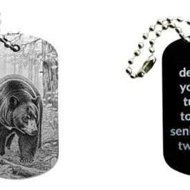 Schwarzer Dogtag Schlüsselanhänger mit Bärenmotiv, daneben Beispiel eines personalisierten Textes auf der Rückseite.
