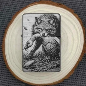Fuchs & Gans Feuerzeug, Schwarz matt mit graviertem Fuchs, der eine Gans im Maul hält, liegend auf einer Holzscheibe.